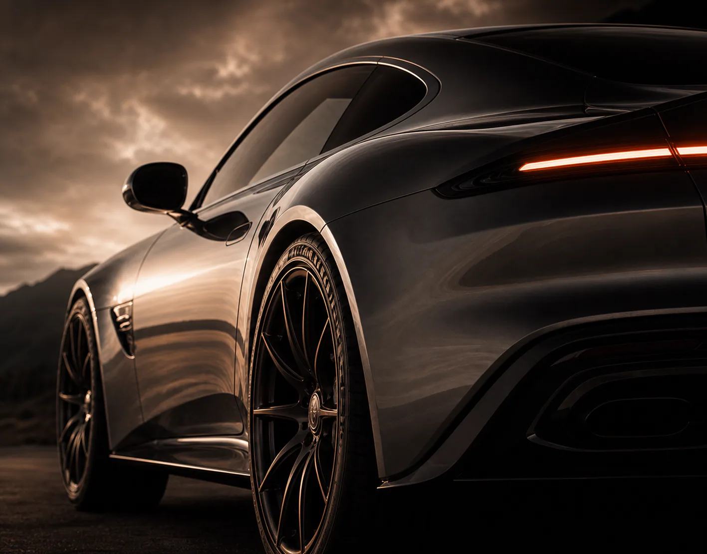 Graphite grand touring coupe on an empty road at dusk