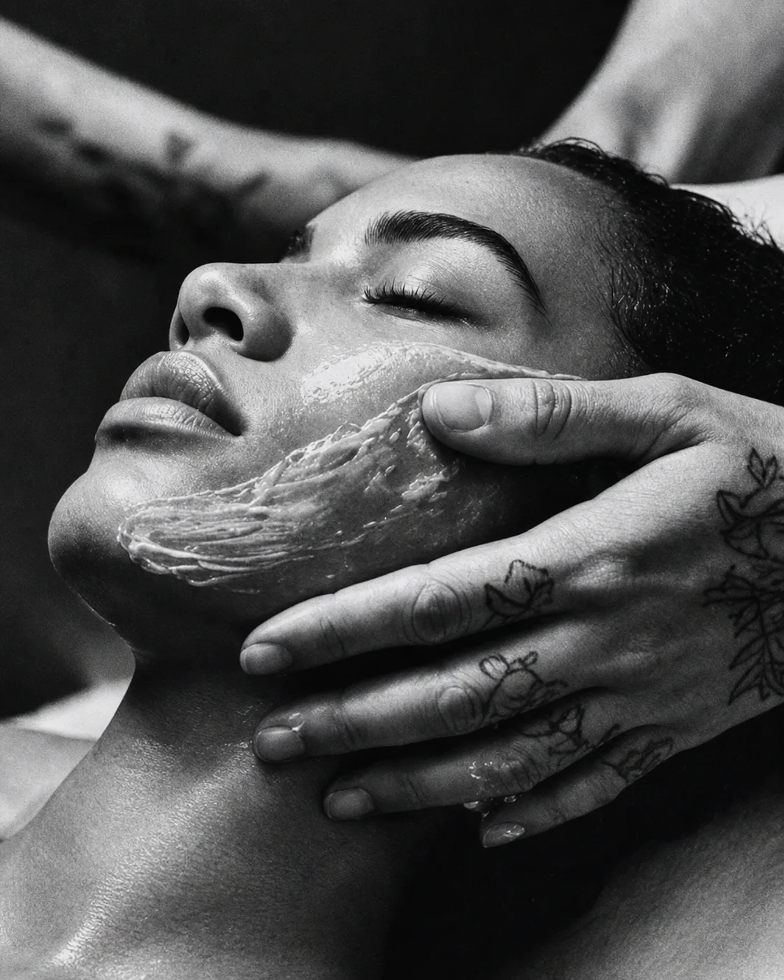 A practitioner applying a facial treatment with careful, slow movements
