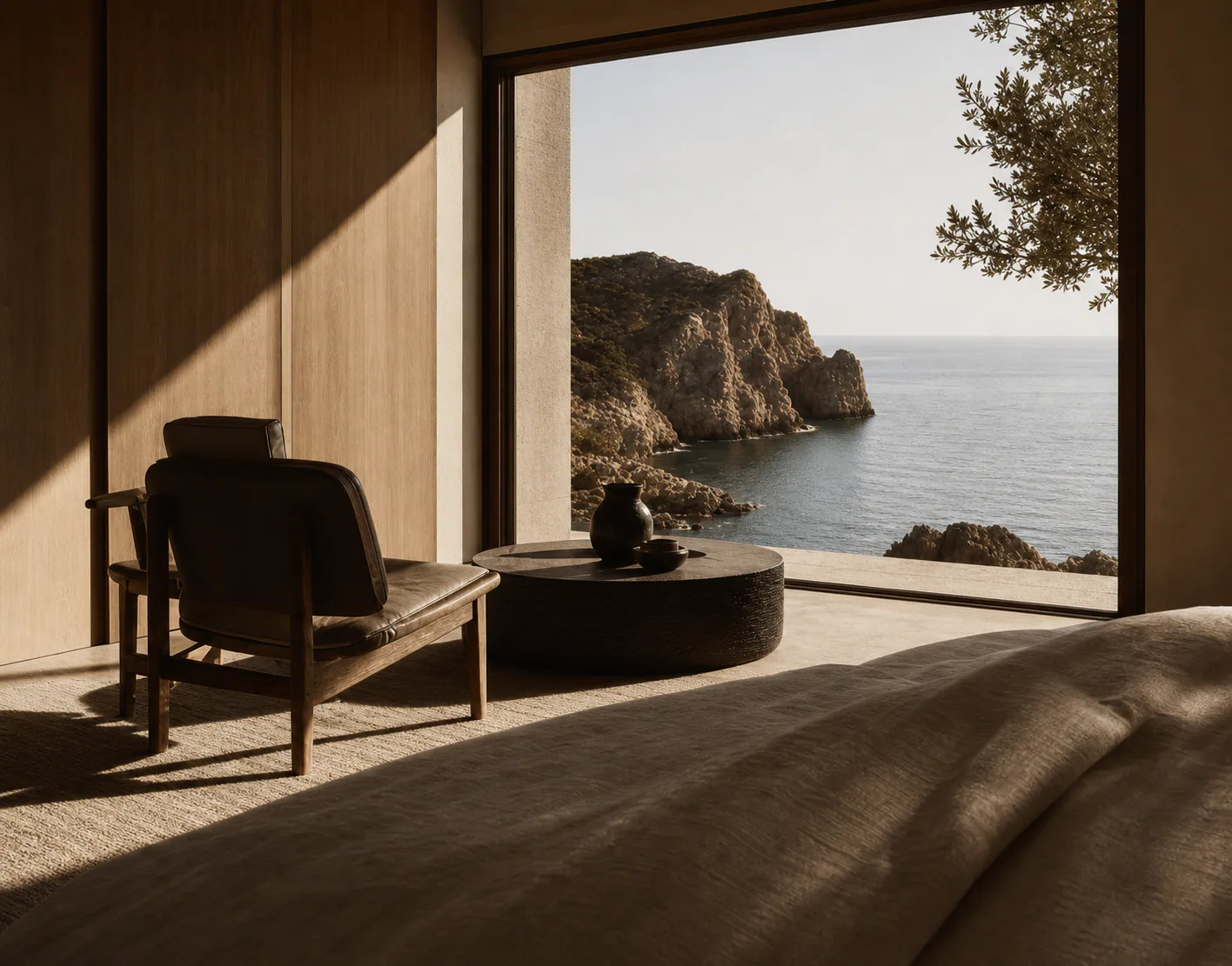 Quiet hotel room with a wide window looking onto a rocky cove