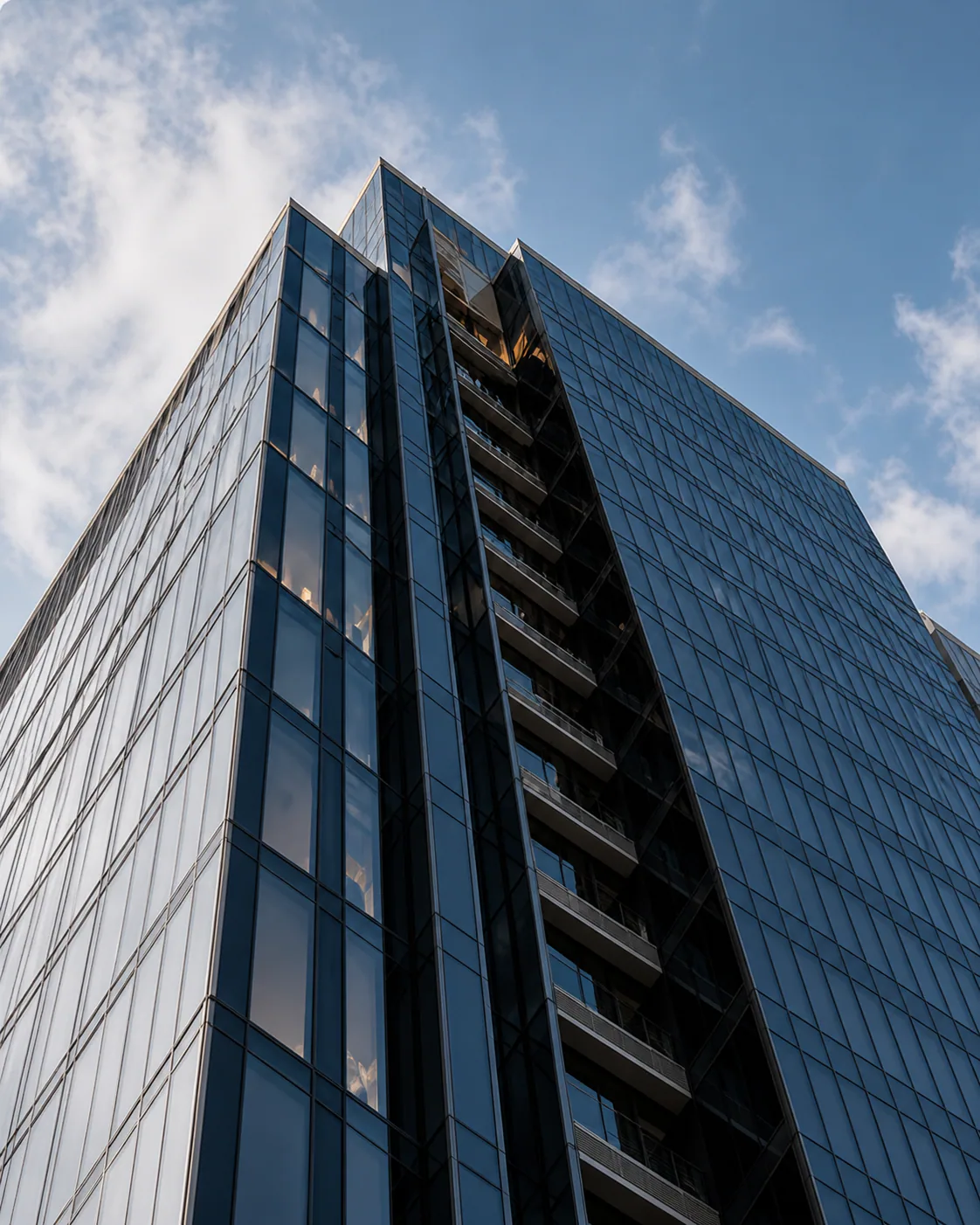 Angular glass commercial tower rising above the city