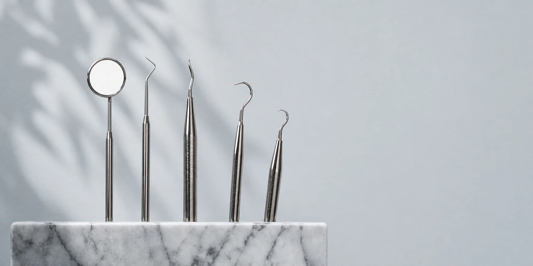 Dental instruments arranged in a quiet stone tray