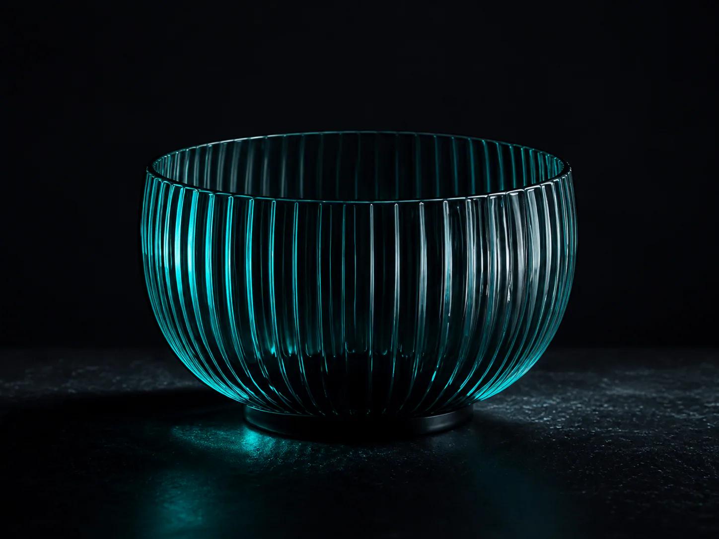 Ribbed cyan glass bowl on a dark surface