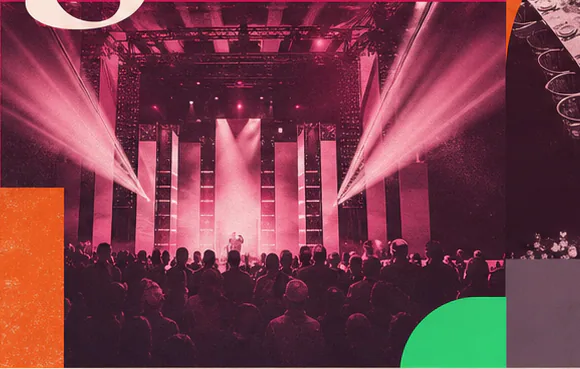 Pink-lit live performance in a crowded event hall