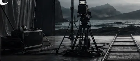 A coastal cliff and a practical film light inside an old room