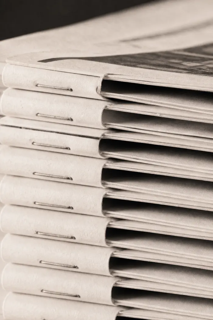 Stack of folded independent newspapers on a table
