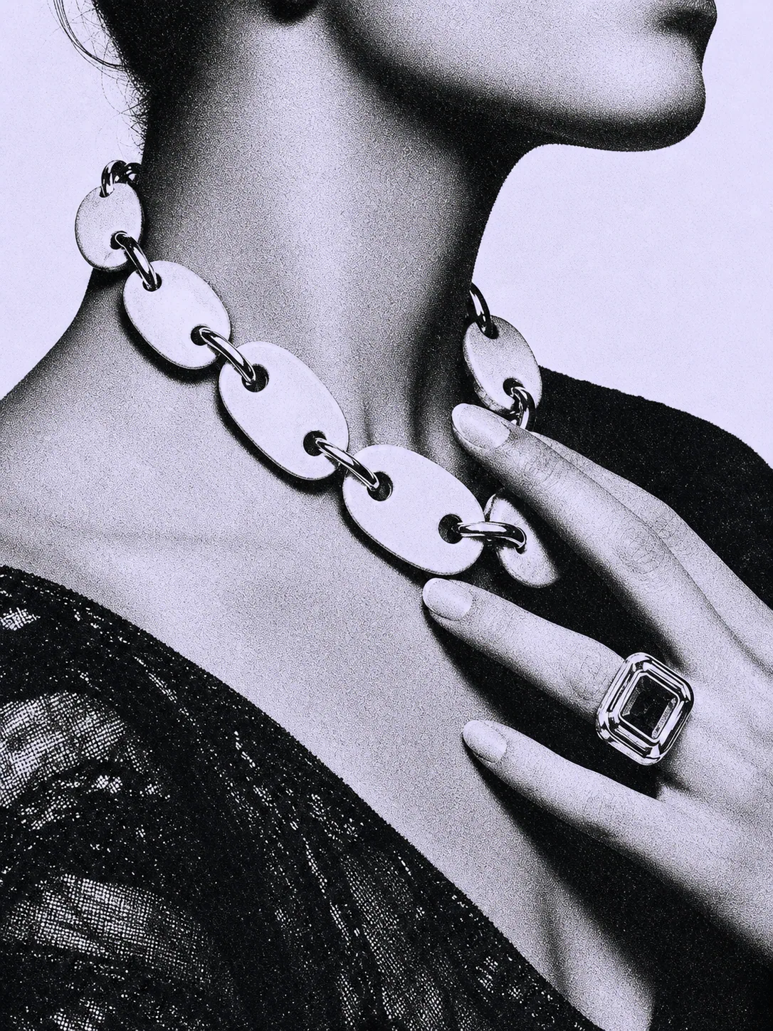 Model wearing a monumental porcelain-link necklace and square statement ring