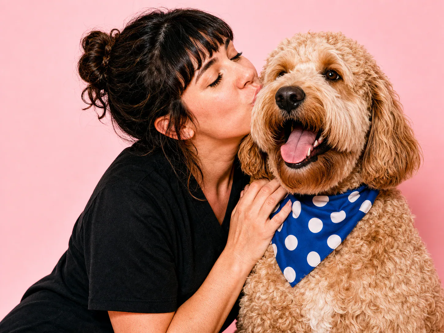 Pet carer cuddling a happy dog