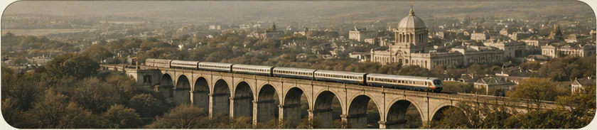 Passenger train crossing a stone viaduct above a historic city