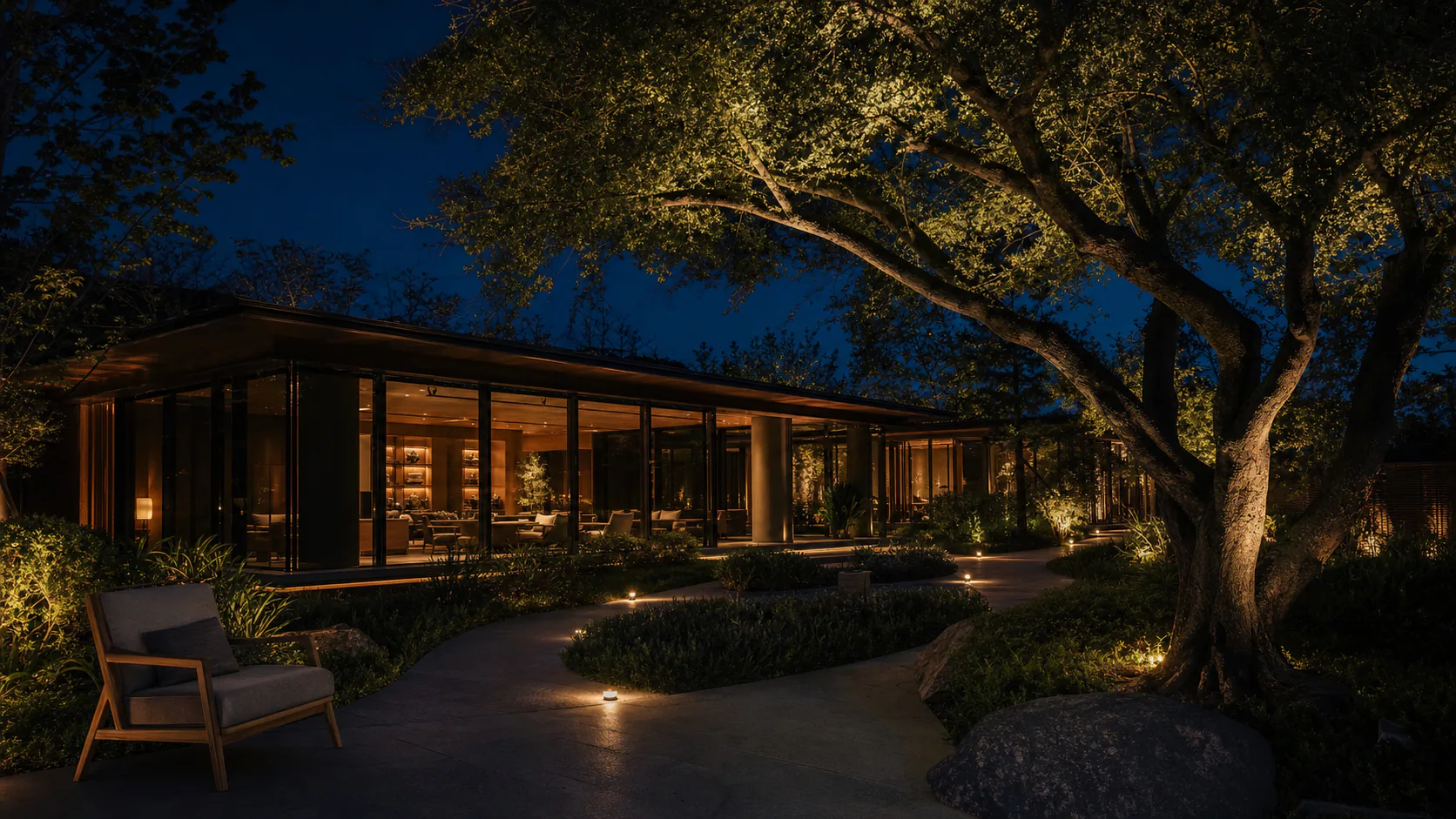 Warmly illuminated garden path at Night Garden Residence