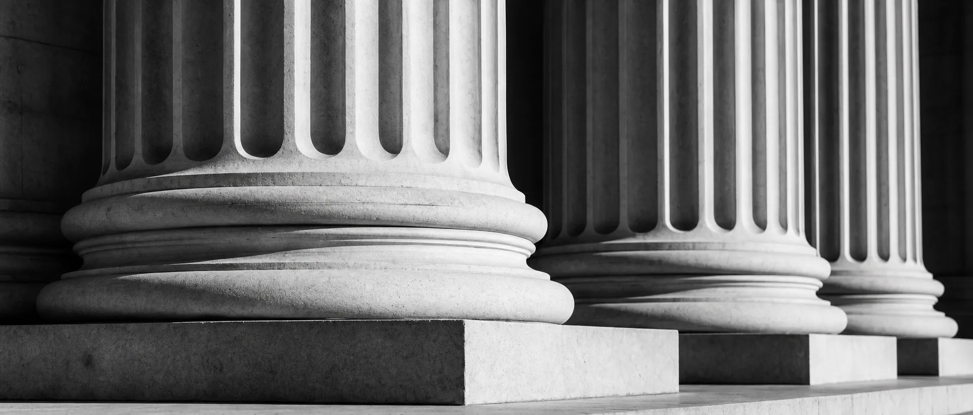 Monumental fluted columns framing a cultural archive entrance