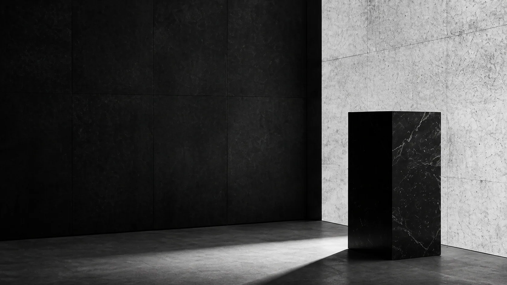 Minimal black and concrete gallery with a marble plinth