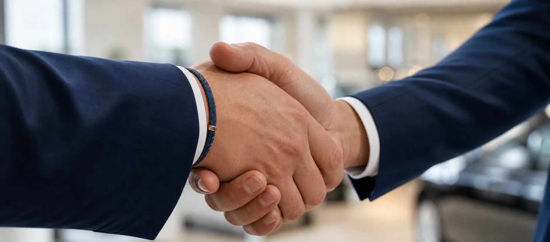 Two people shaking hands after a showroom consultation