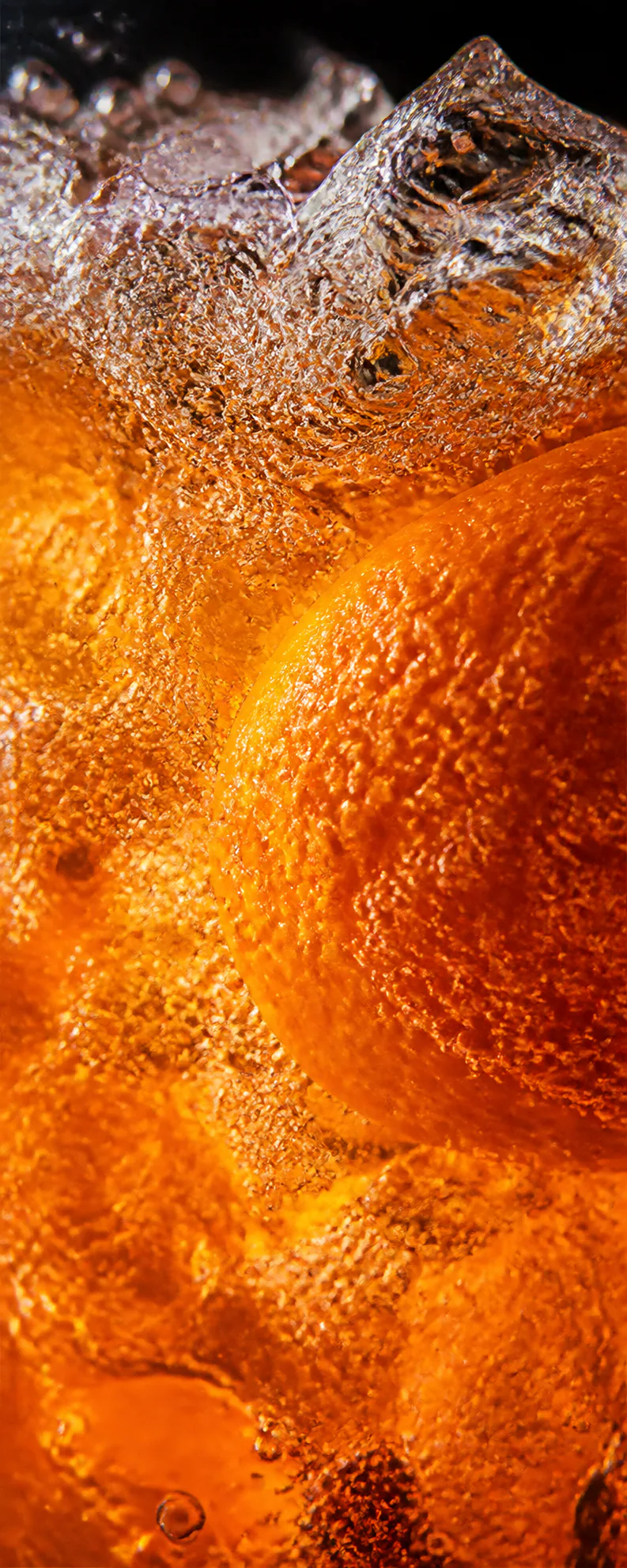 Macro view of orange soda and ice