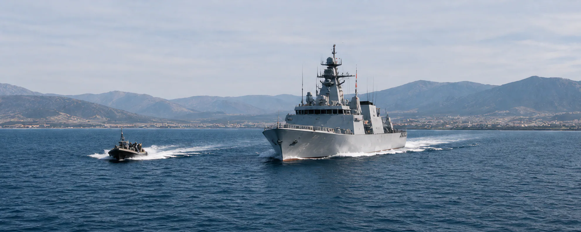 Mission ship moving through a coastal channel
