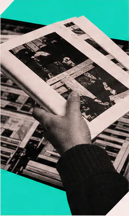 Hands reviewing a printed spread