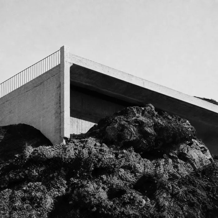 Concrete lookout built into a dark rocky hillside