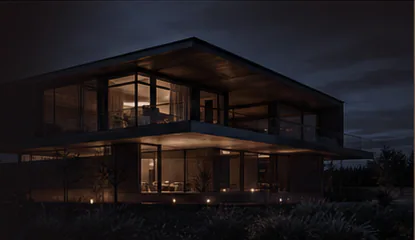 Warm modern home glowing at night under a dark sky