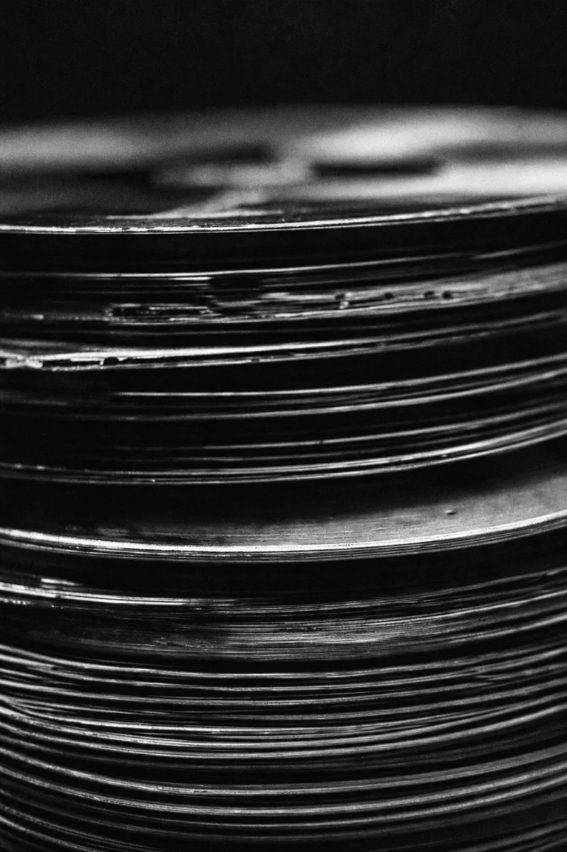 Stacked vinyl records seen edge-on in monochrome light