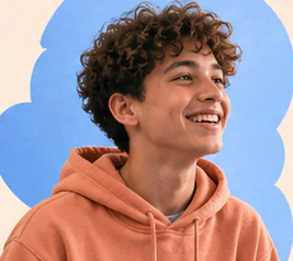 Student smiling in an orange hoodie