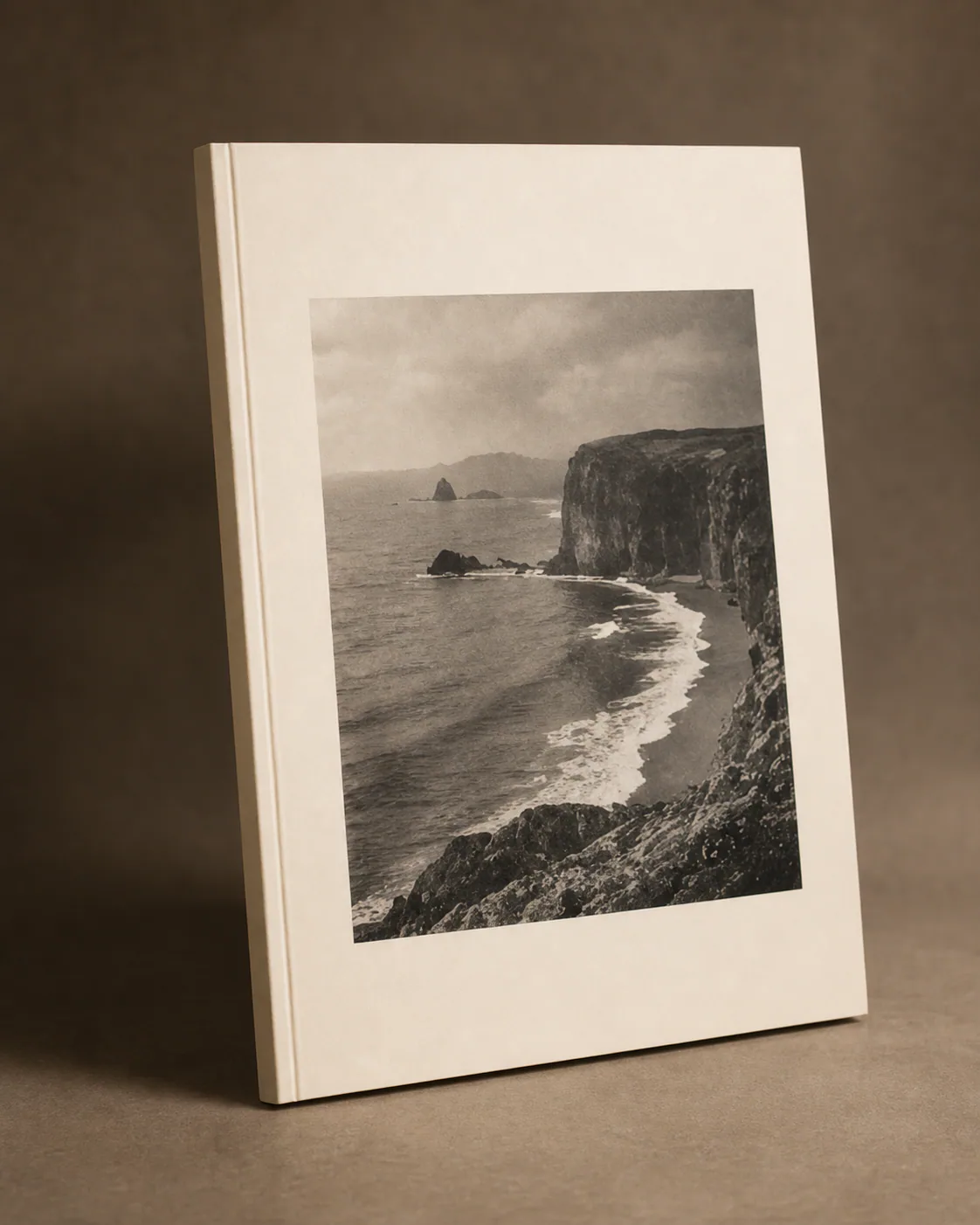 Coastline photography book on a dark table