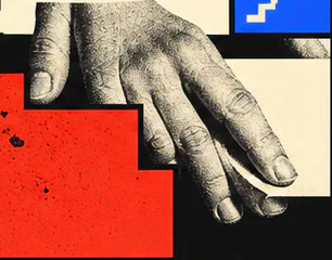 Hand arranging a graphic block on a work surface