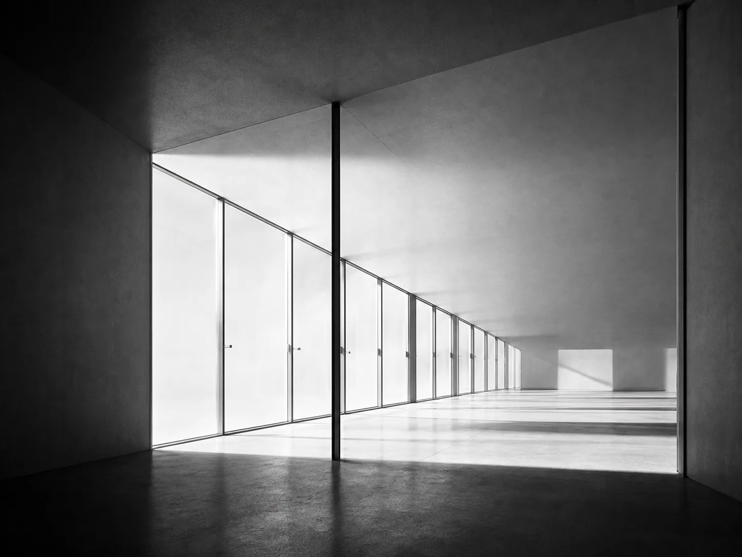 Minimal gallery corridor receding into bright light