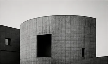 Cylindrical concrete archive building with a deep entrance