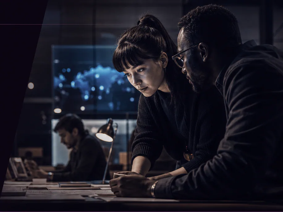 Two colleagues reviewing a project together at a late-night studio table