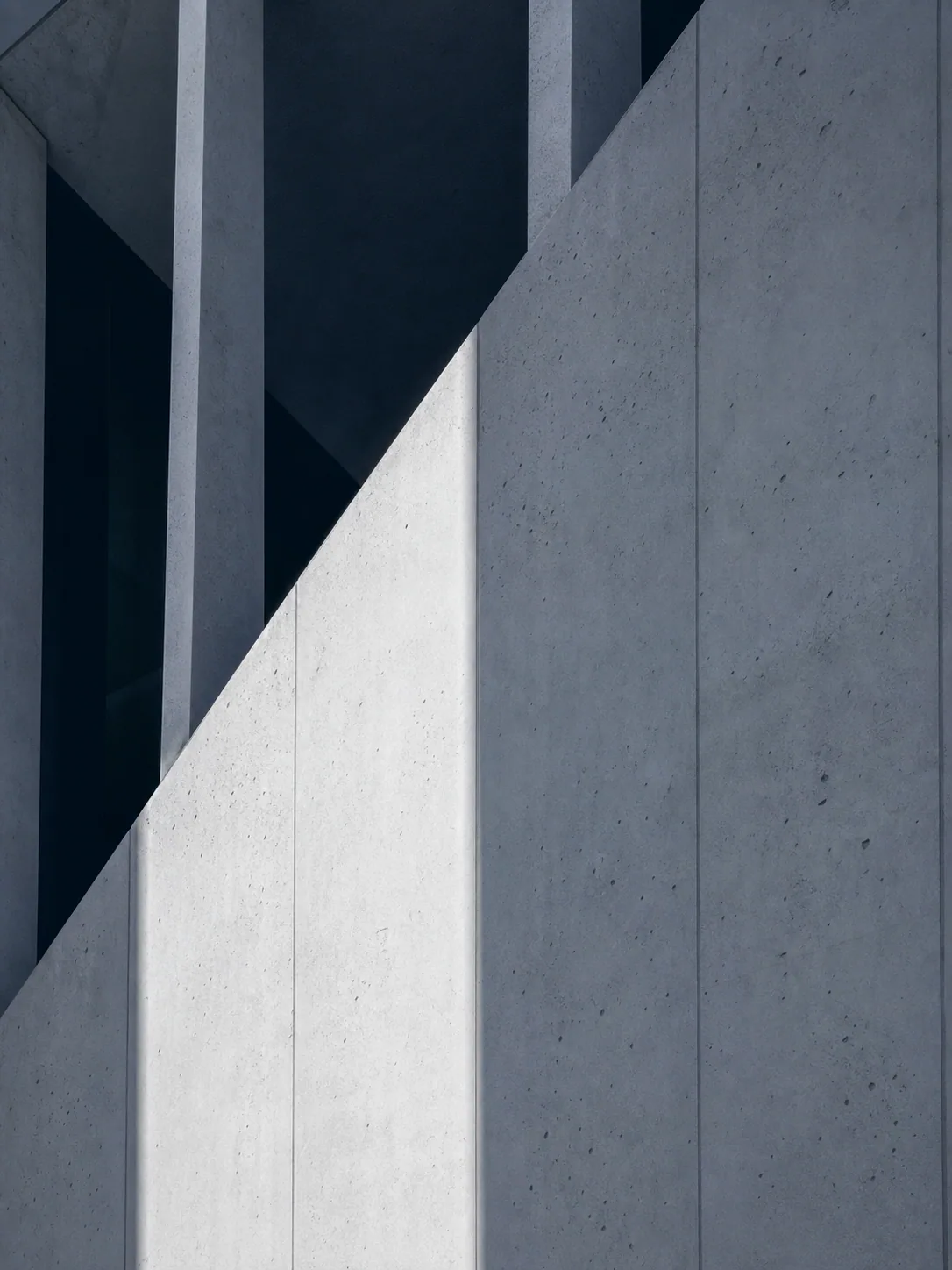 Light moving across the planes of a concrete building